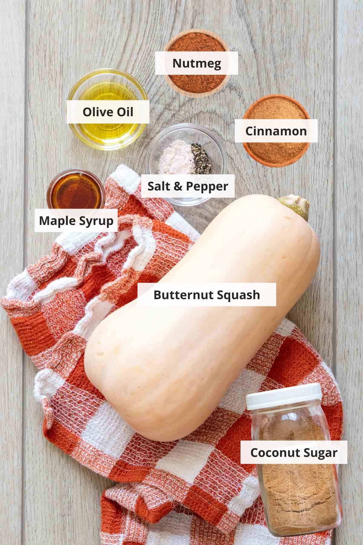 Ingredients for whole roasted butternut squash recipe on a light wood countertop.