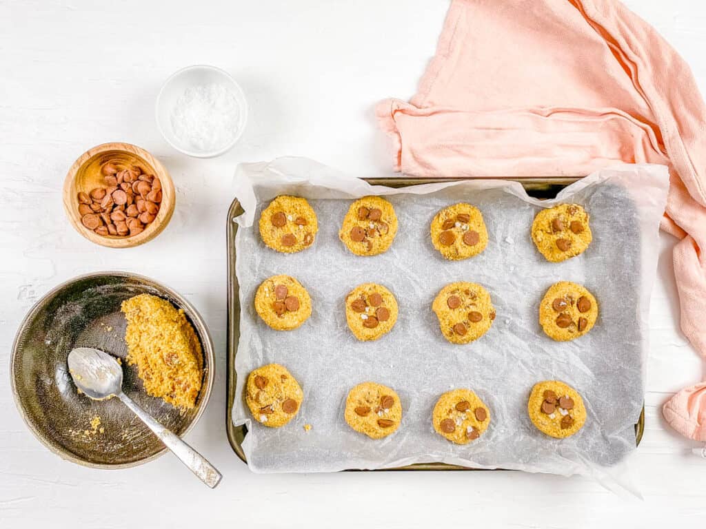 Cookie dough balls on a baking sheet.