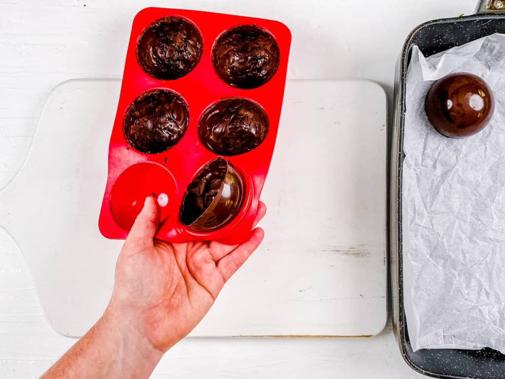 Hot chocolate bomb shells in a silicone mold.