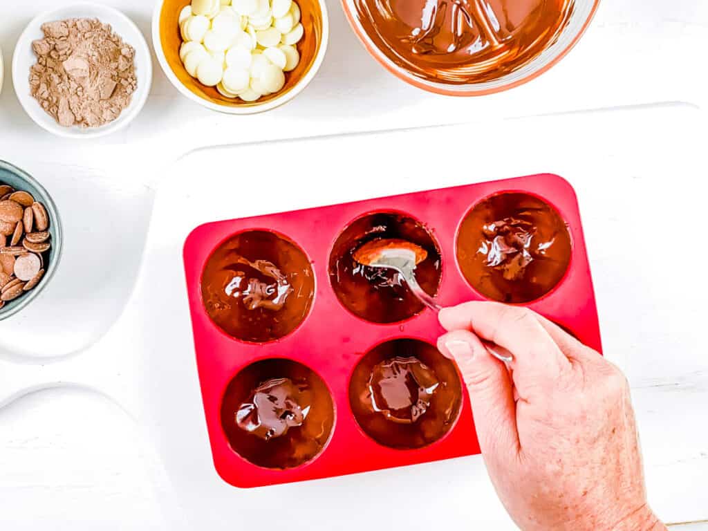 Boozy hot chocolate bomb shells in a silicone mold.