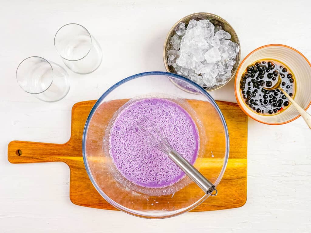 Ube extract and taro root powder mixed in a bowl.