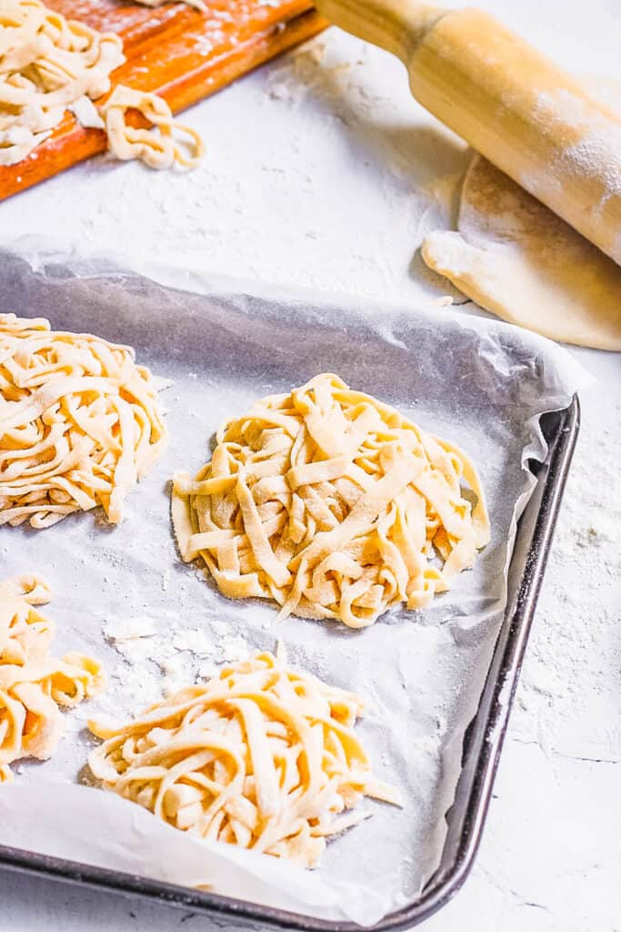 3 ingredient homemade vegan pasta on a baking sheet lined with parchment paper.