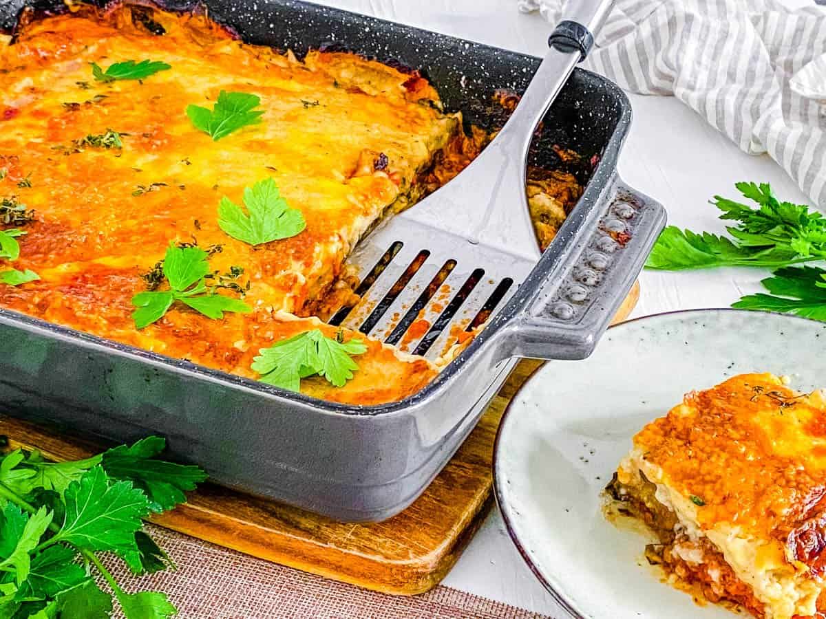 Baked vegan moussaka in a baking dish, fresh out of the oven.