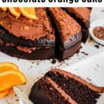 a chocolate cake with ganache and oranges on top