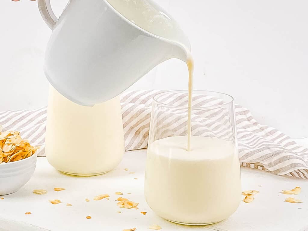 Coconut cream pie shake poured into a glass.