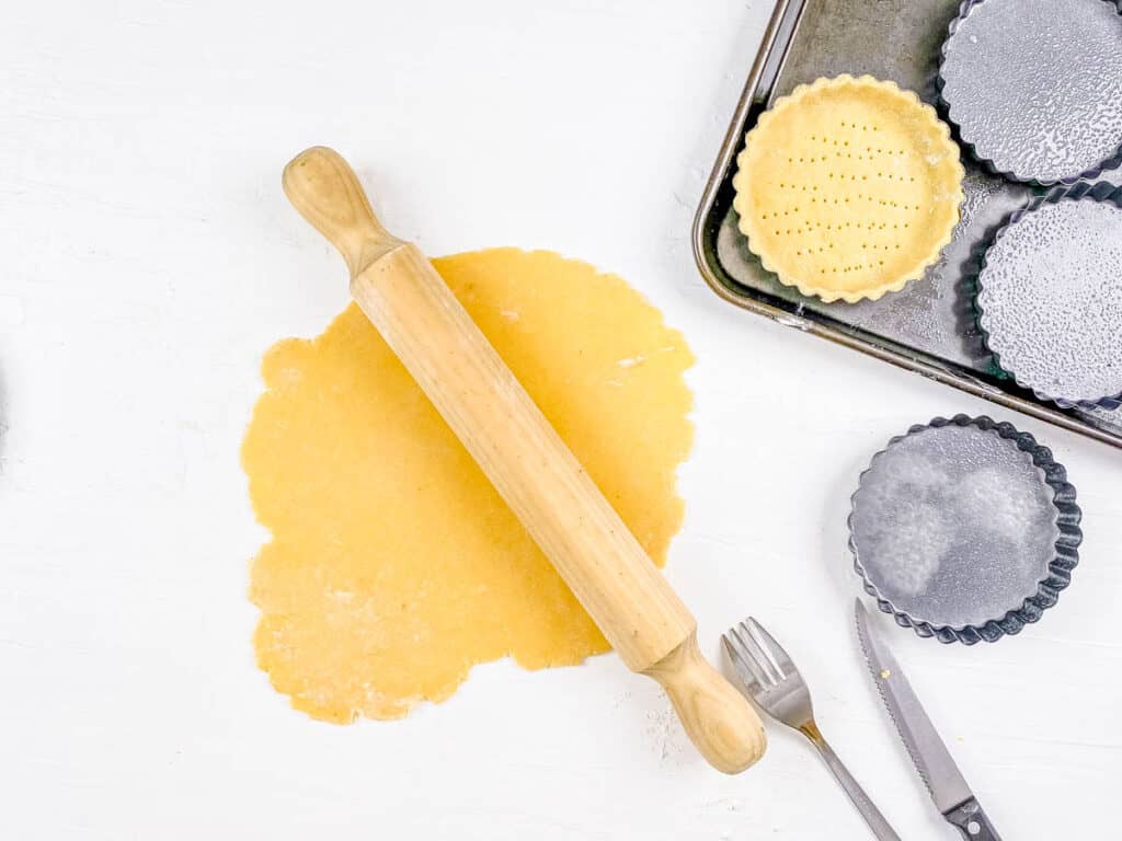 Pastry dough rolled out on a work surface.