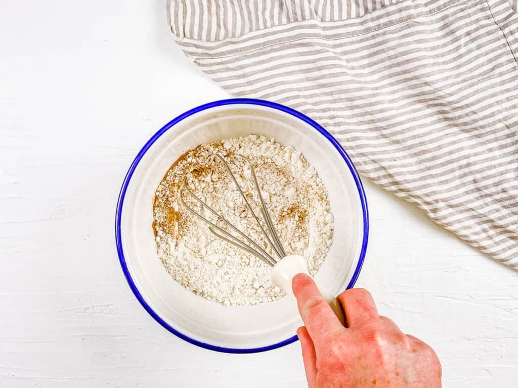 Gluten free flour mixed in a bowl with a whisk.