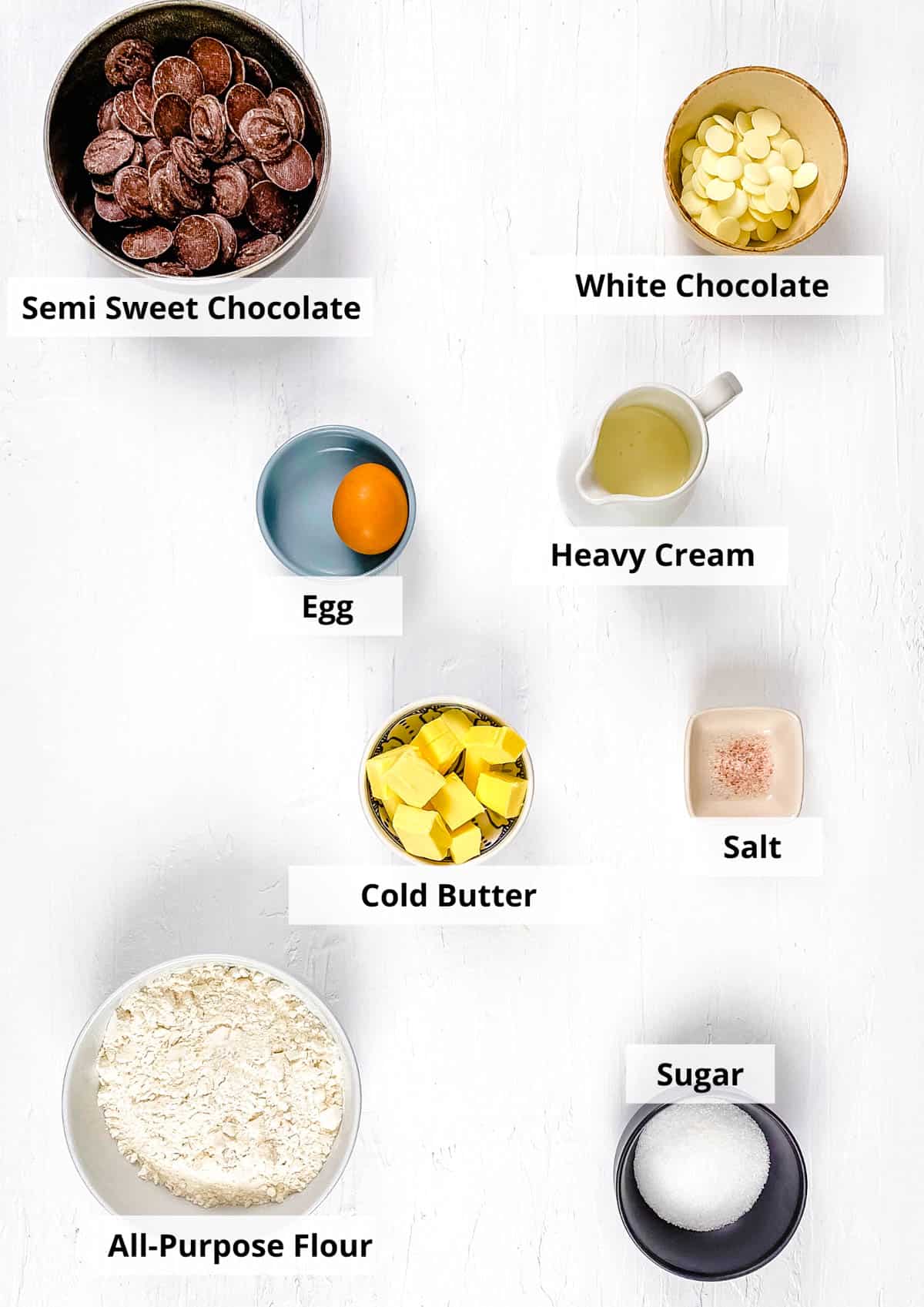 Ingredients for mini chocolate tart recipe on a white background.