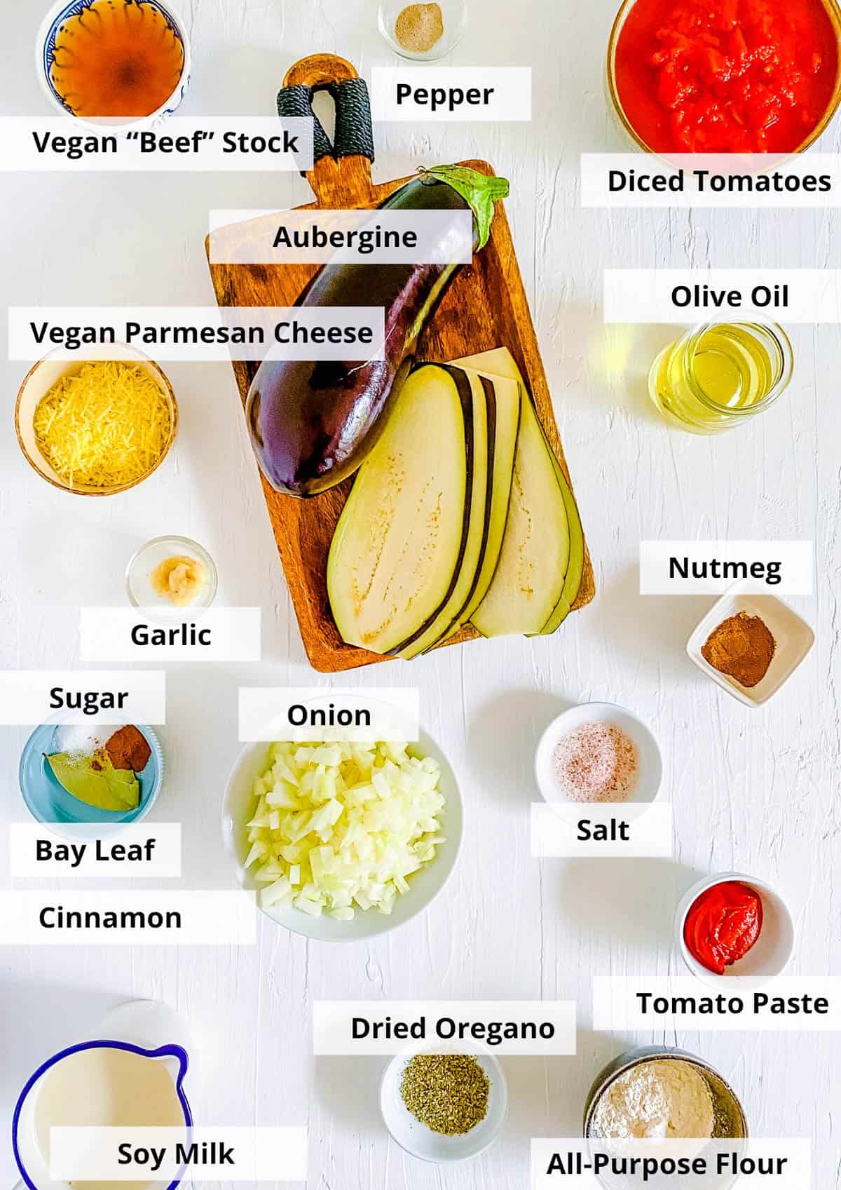 Ingredients for vegan moussaka recipe on a white background.