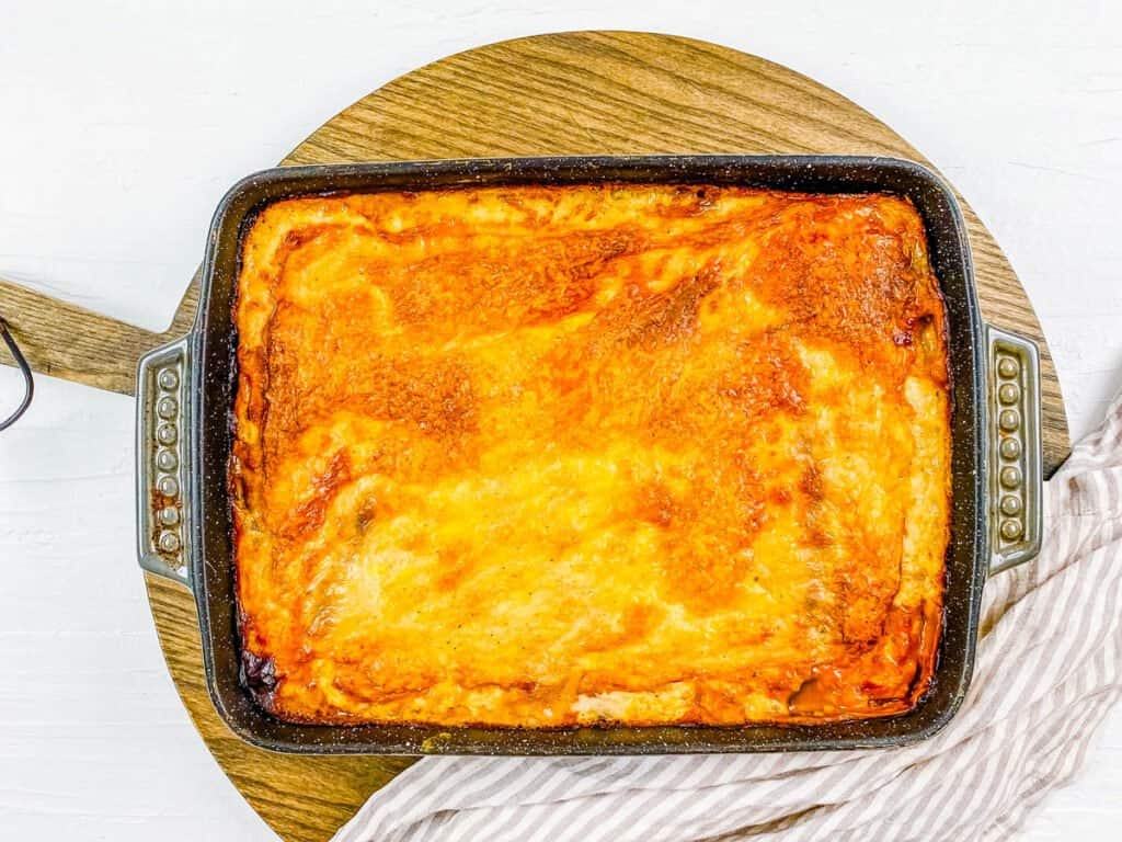 Baked meatless moussaka in a baking dish, fresh out of the oven.