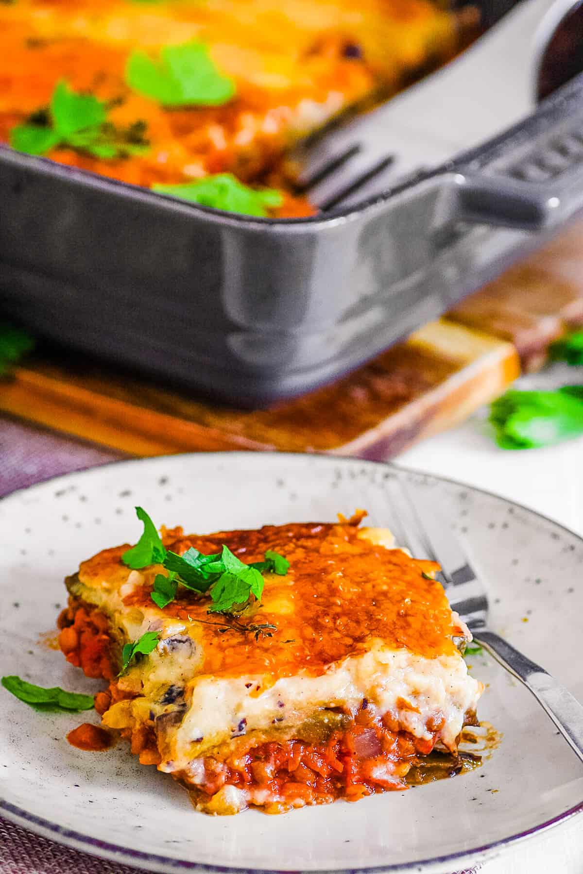 Slice of vegan moussaka on a white plate.