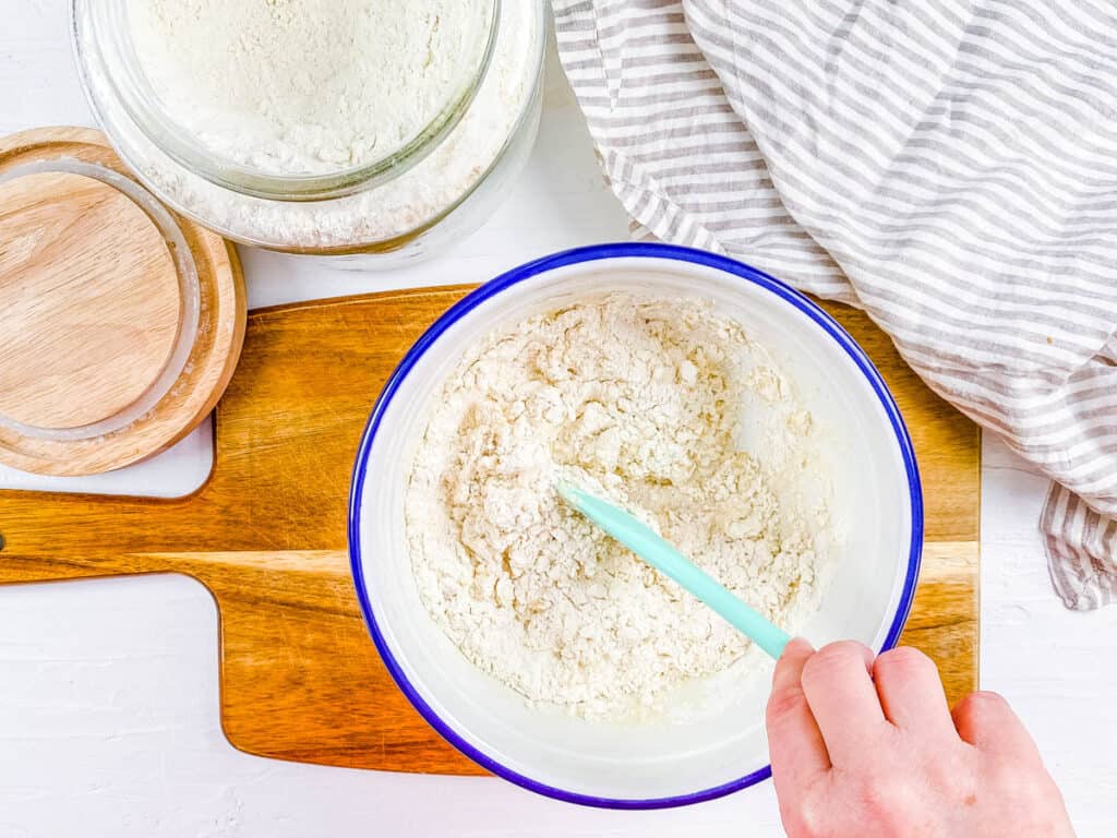 Dough for no yeast flatbread being mixed in a bowl.