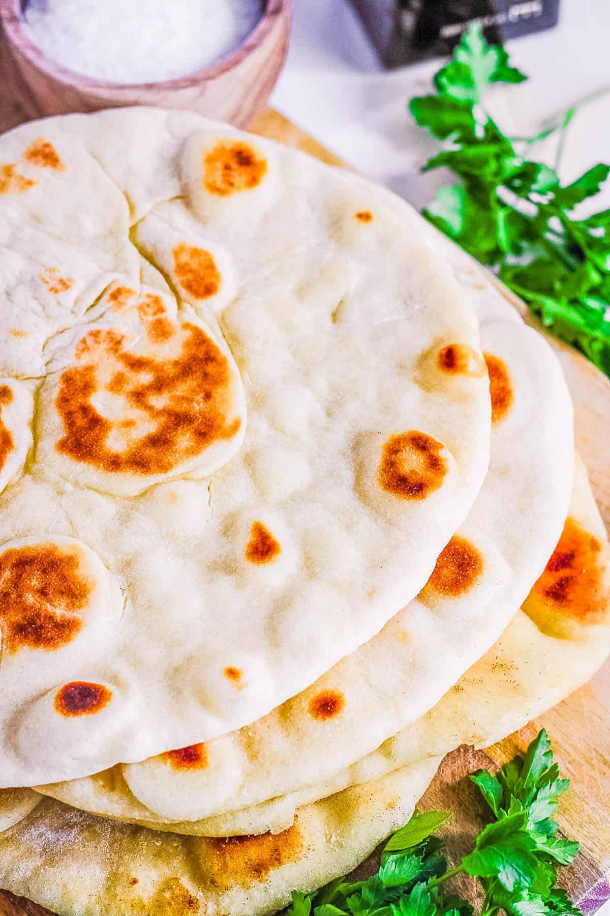 Yeast free vegan flatbread stacked on a cutting board.