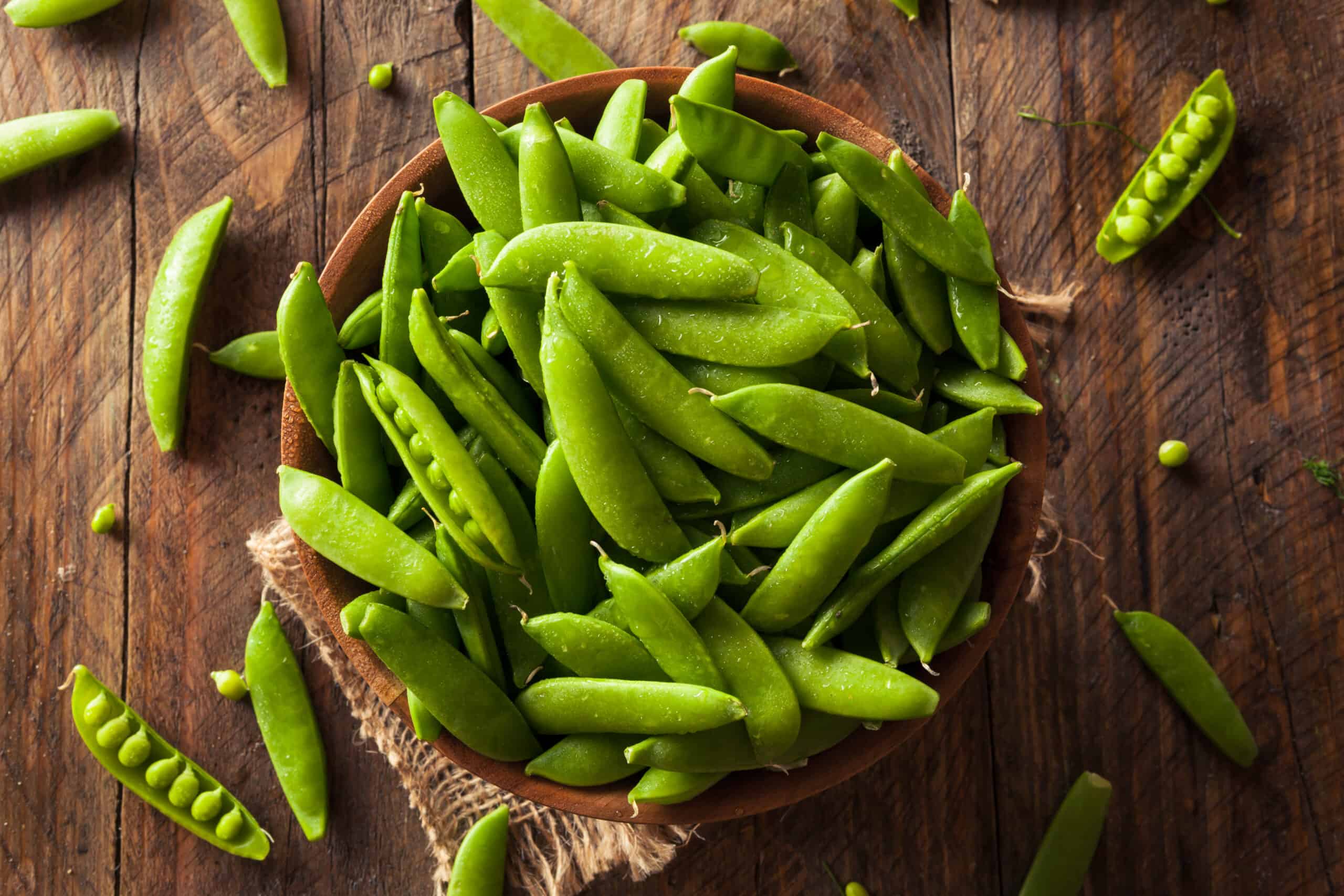 Photo of Mangetout in a wooden bowl.