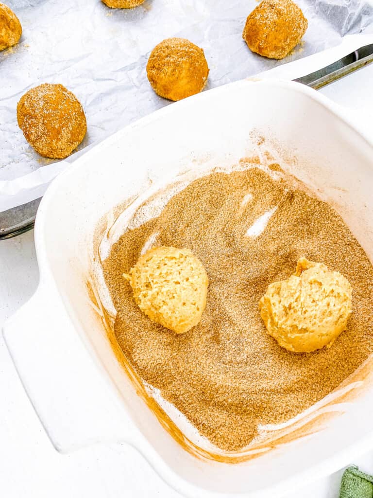 Baking powder snickerdoodle cookie dough balls rolled in cinnamon sugar coating.