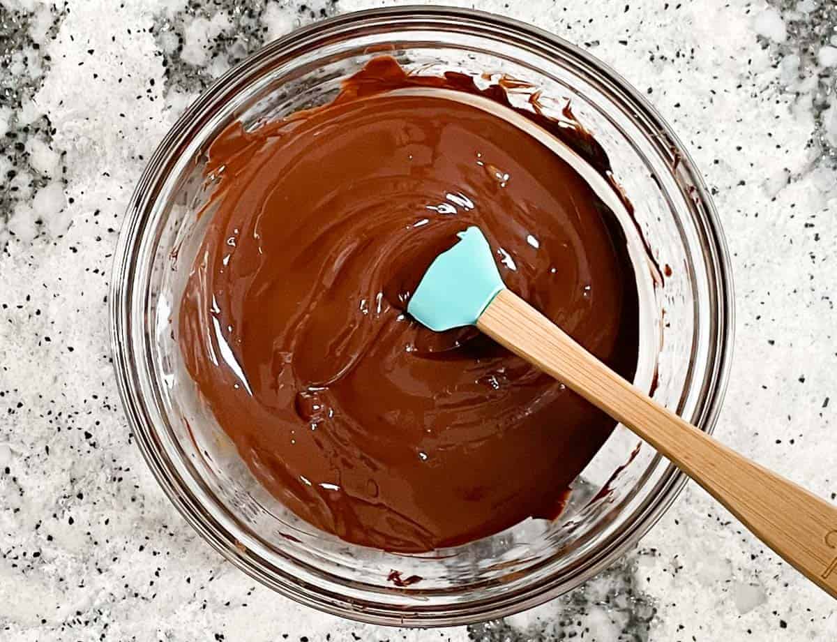 Melted chocolate is glass bowl.