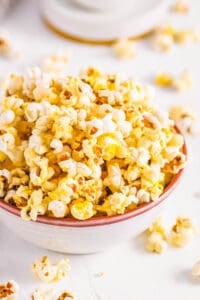 Instant pot popcorn served in a white bowl on a white countertop.