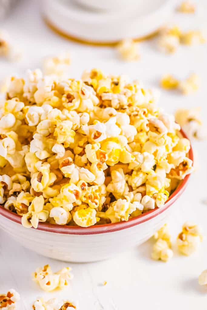 Instant pot popcorn served in a white bowl on a white countertop.