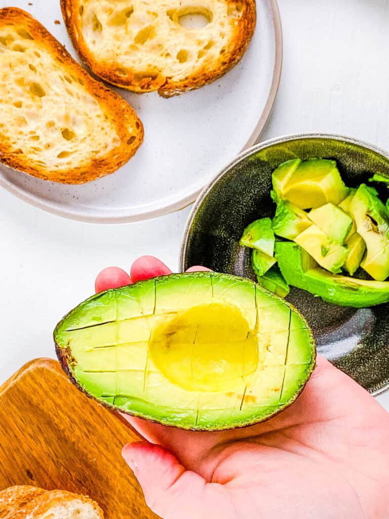 Sliced and diced avocado in a bowl.