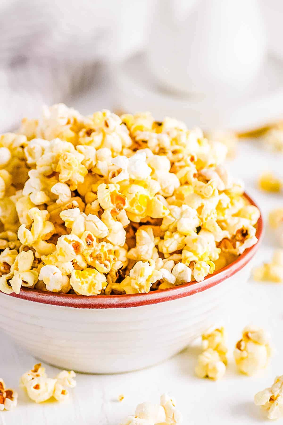 Instant pot popcorn served in a white bowl on a white countertop.