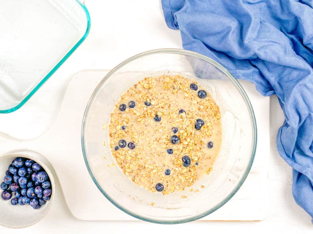 Rolled oats and berries combined in a mixing bowl.