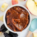 Prune puree for baby served in a white bowl.