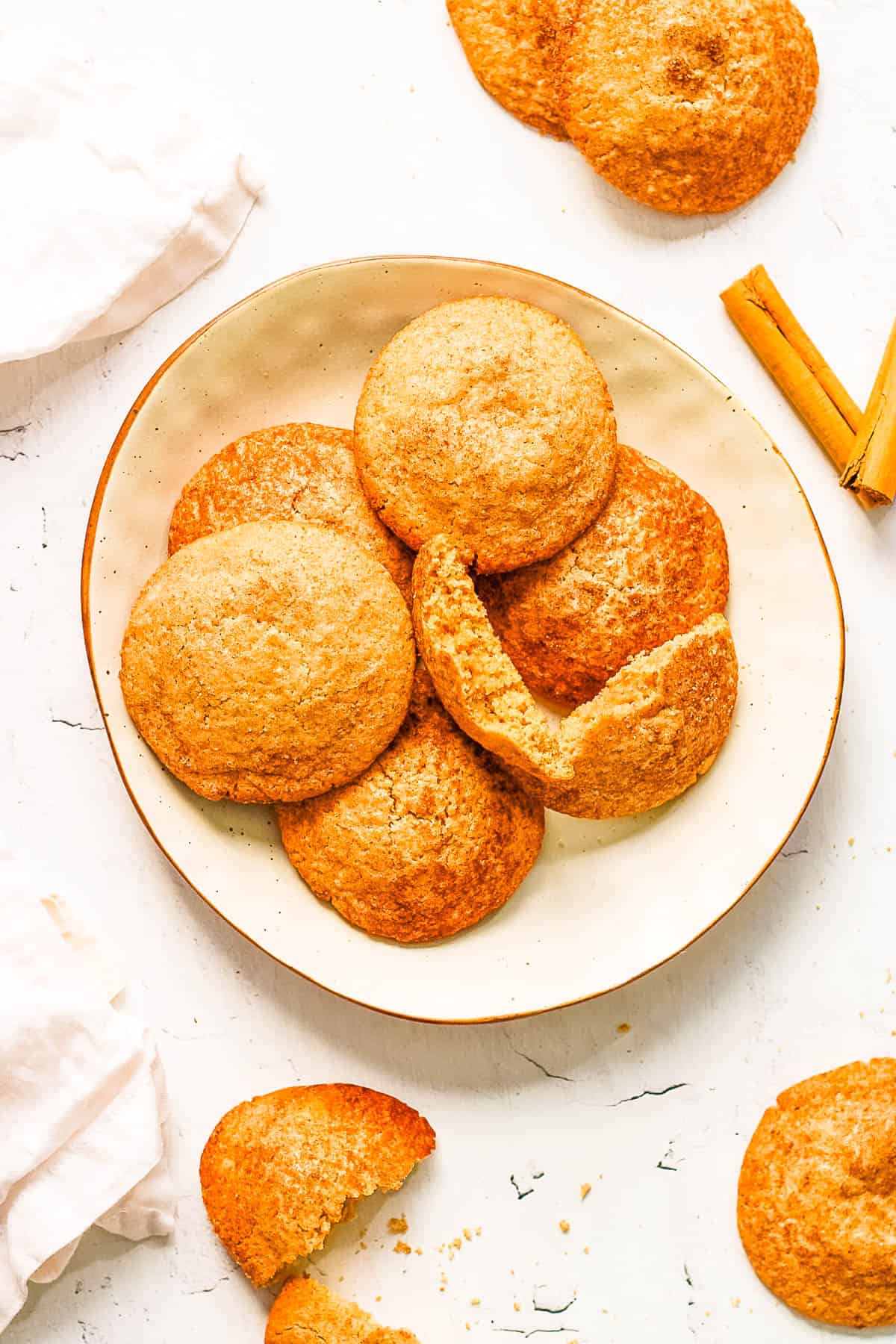 Snickerdoodles without cream of tartar stacked on a white plate.