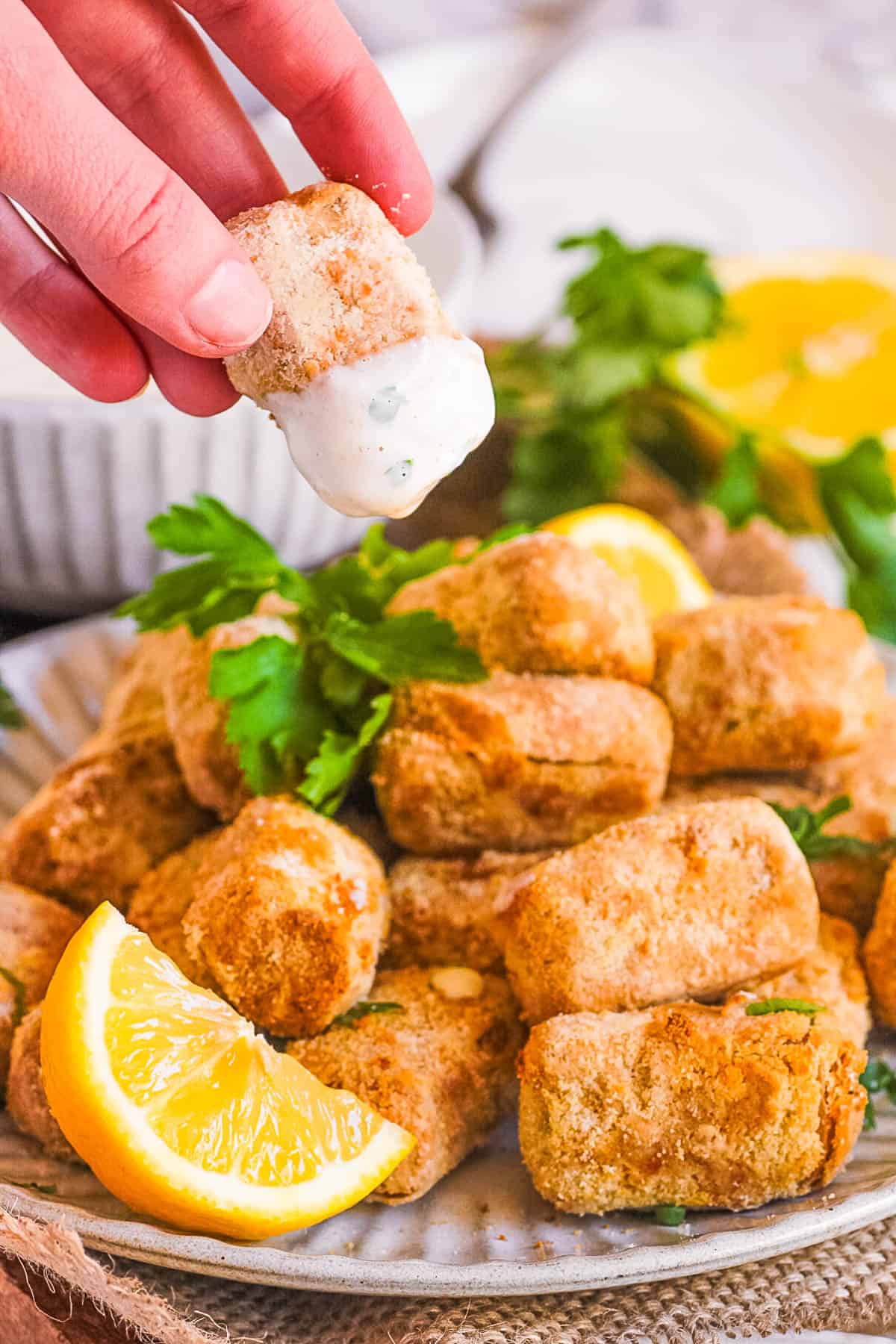 Vegan air fried tofu with ranch dipping sauce on a white plate.