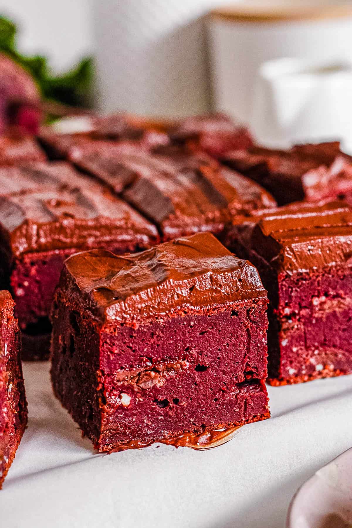 Dark chocolate beet brownies cut and presented on a white tray.