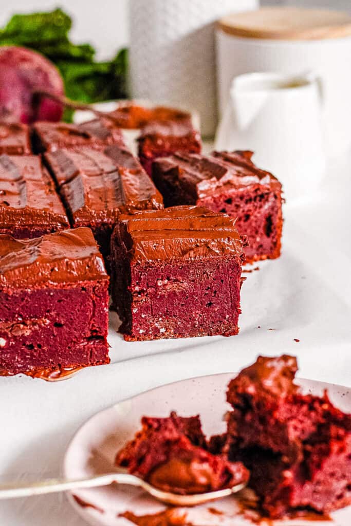 Healthy beet brownies cut and presented on a white tray.