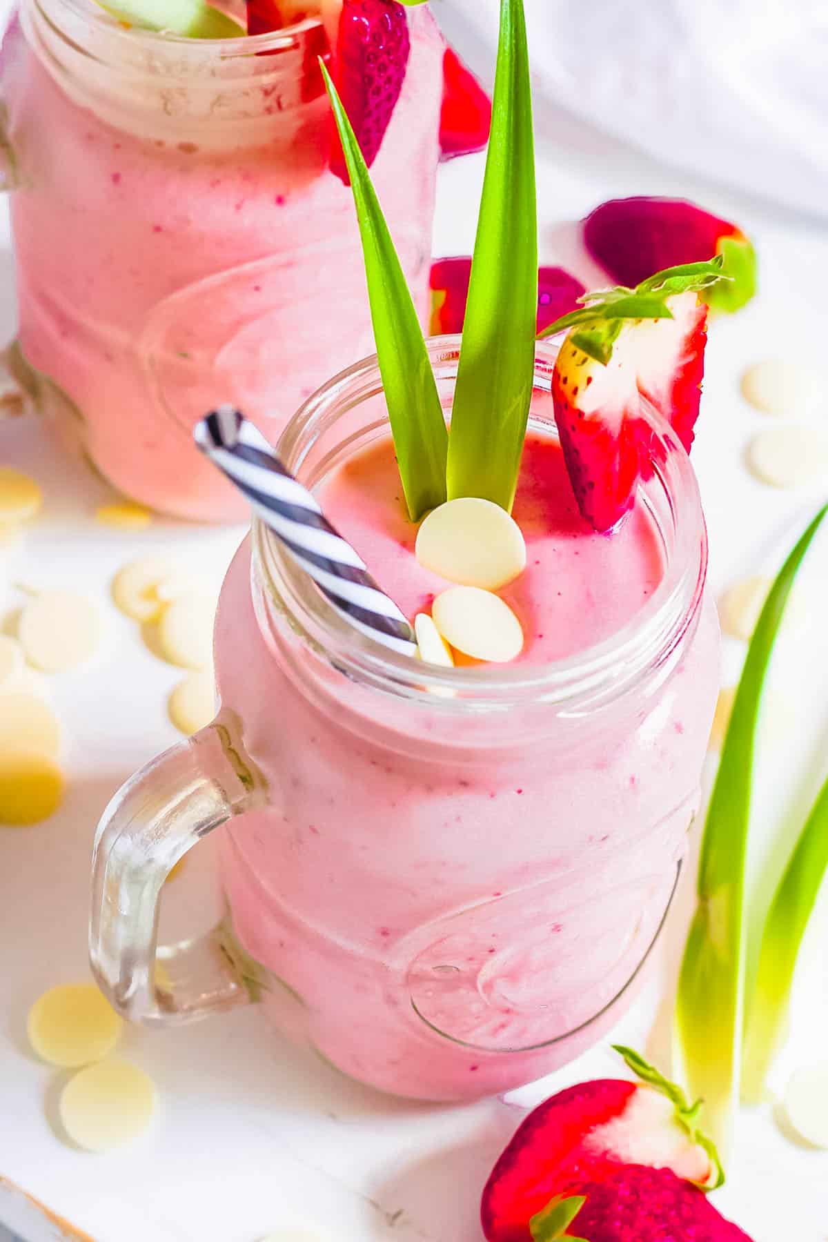 Bahama mama tropical smoothie recipe copycat in a glass mug garnished with white chocolate and strawberries.