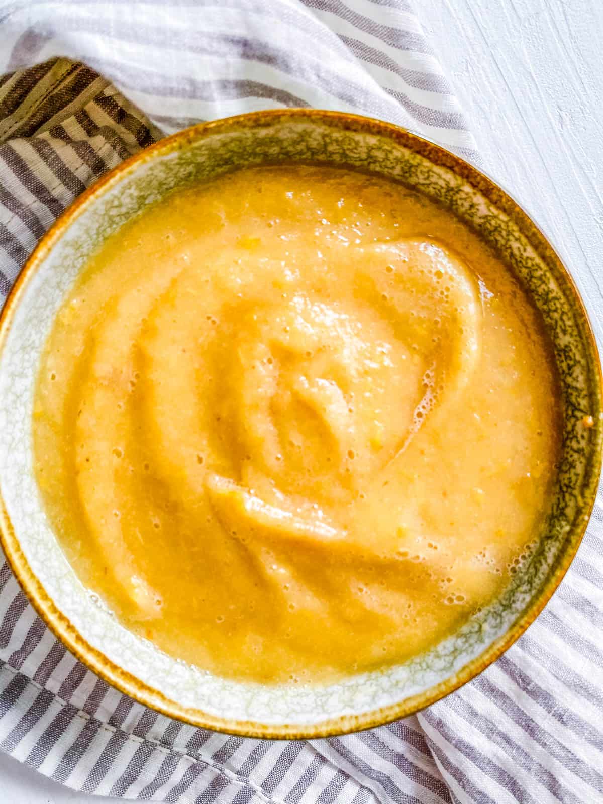Homemade pear baby food recipe in a small bowl.