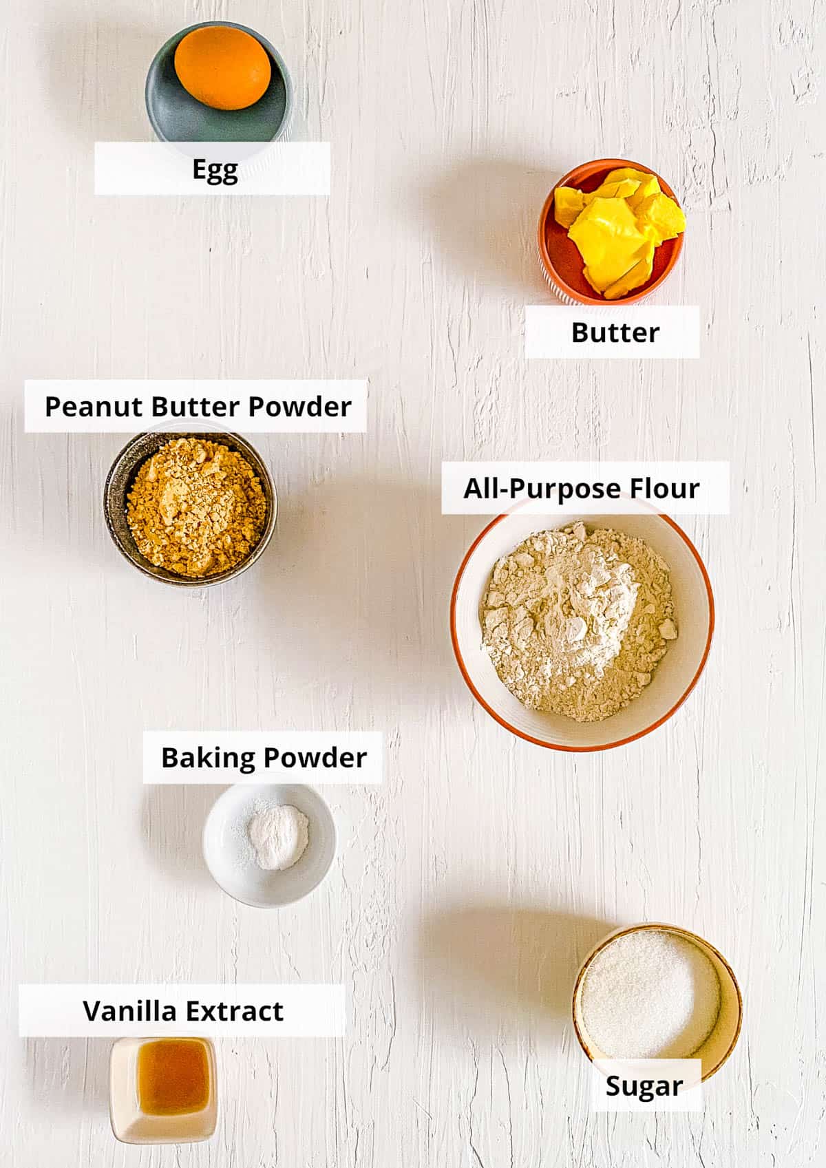 Ingredients for easy powdered peanut butter cookies recipe on a white background.