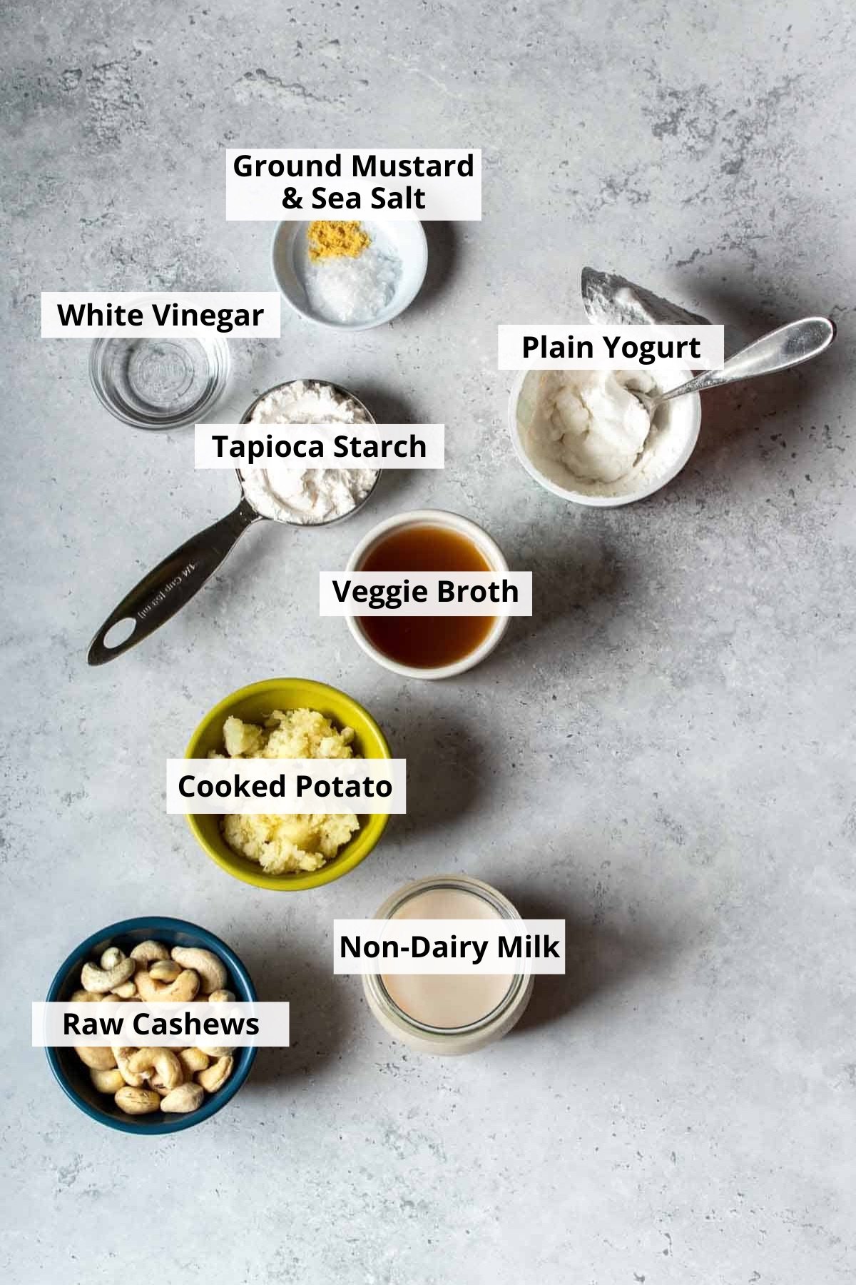 Top view of different bowls with ingredients to make a cashew based cheese.