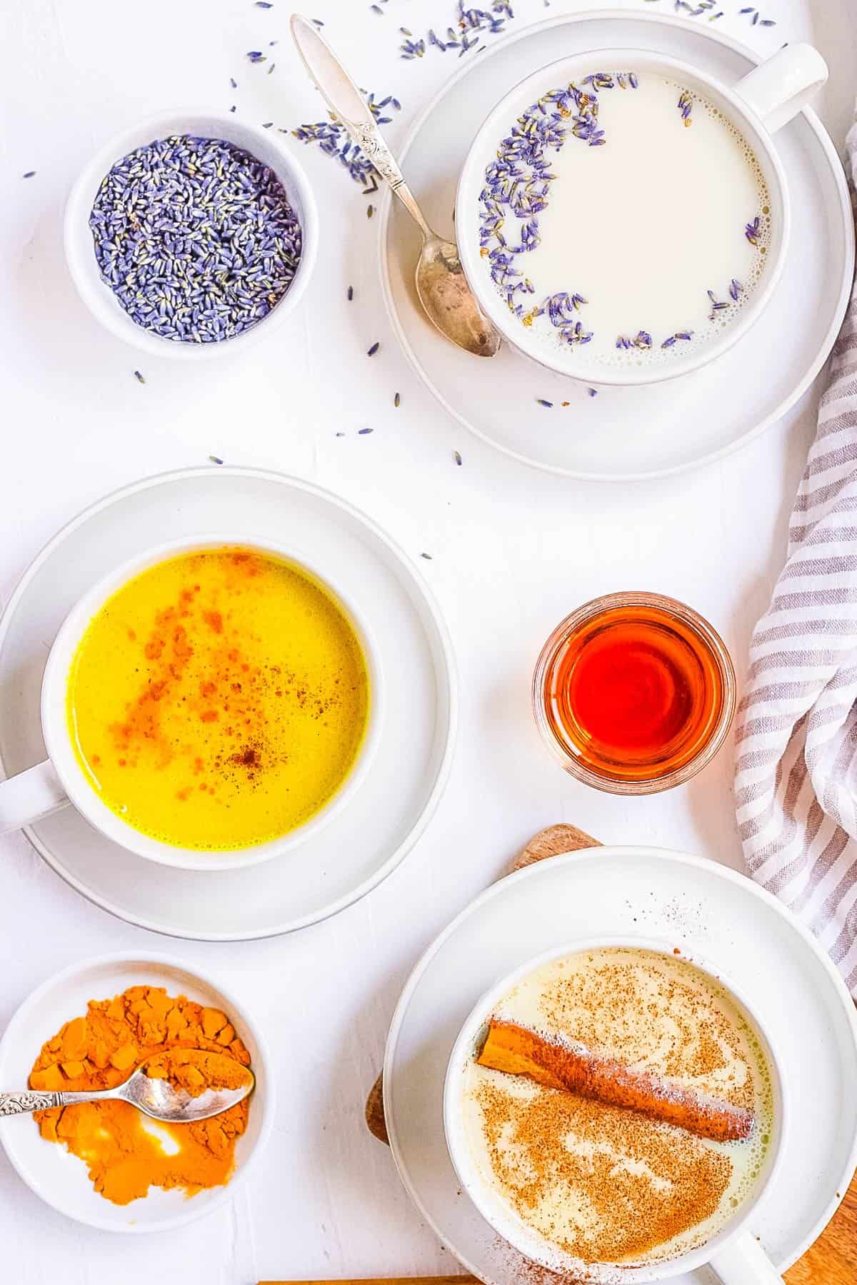 Moon milk s،wn 4 ways: traditional, lavender flavored, turmeric flavored, and chai ،ed.