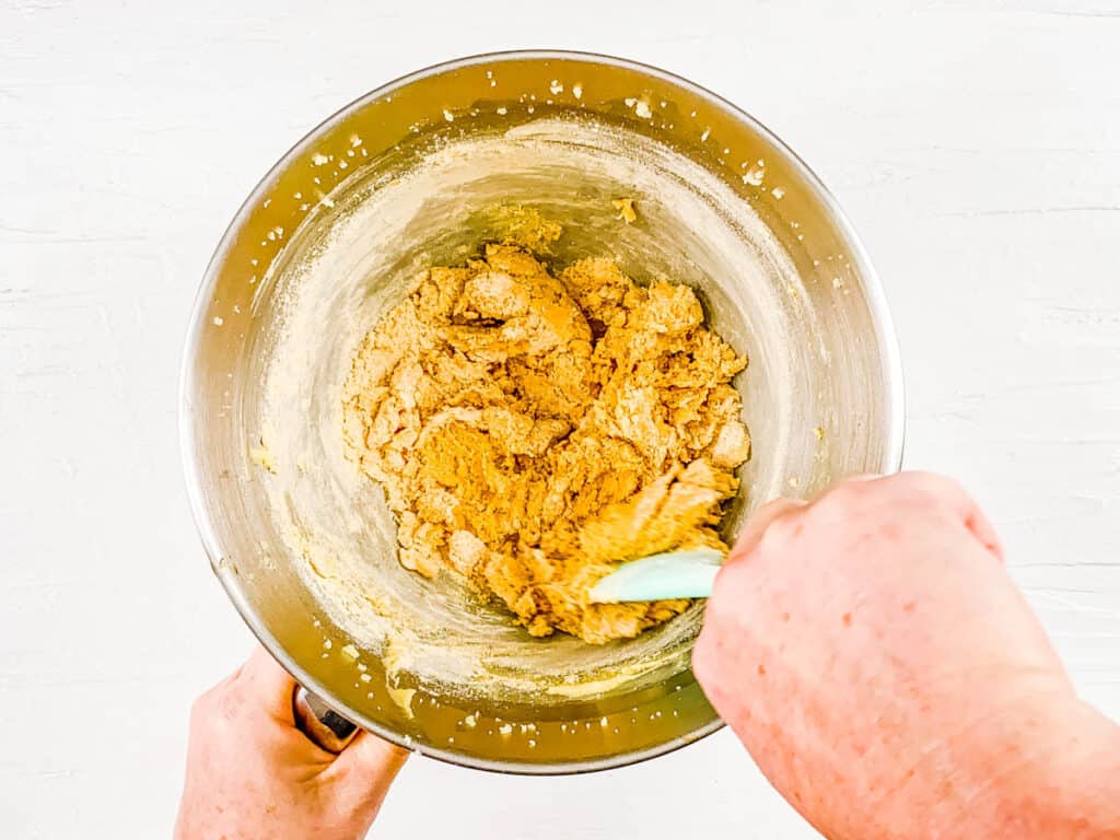 Cookie dough for peanut butter powder cookies in a mixing bowl.