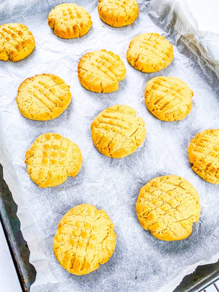 PB Fit cookies on a baking sheet lined with parchment paper.