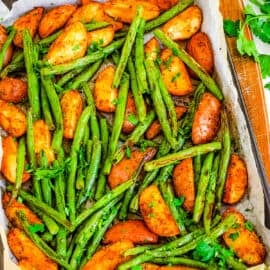 Oven roasted green beans and potatoes on a sheet pan.