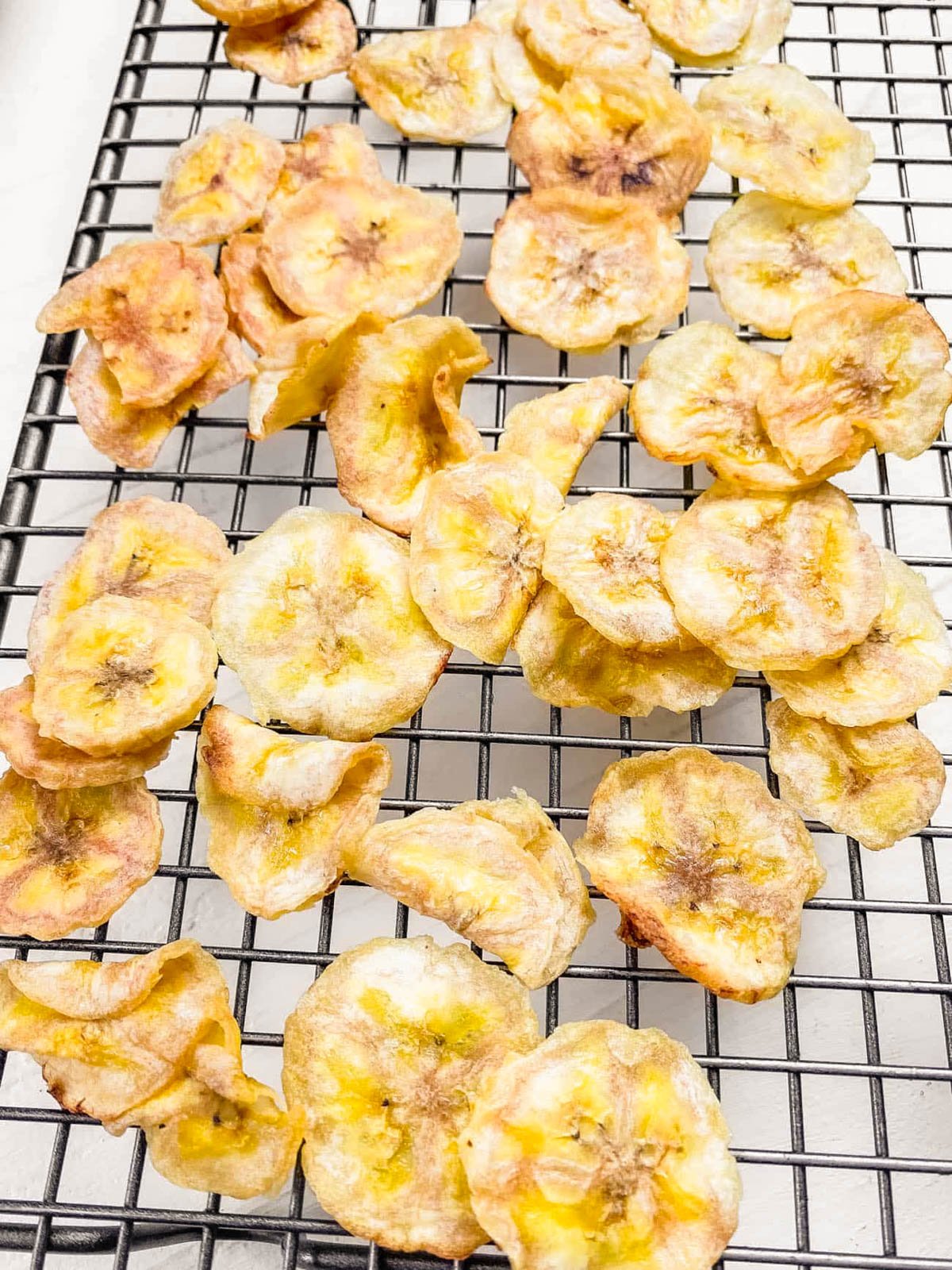 Air fryer banana chips on a wire rack.