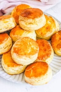 Biscuits without baking powder stacked on a plate.