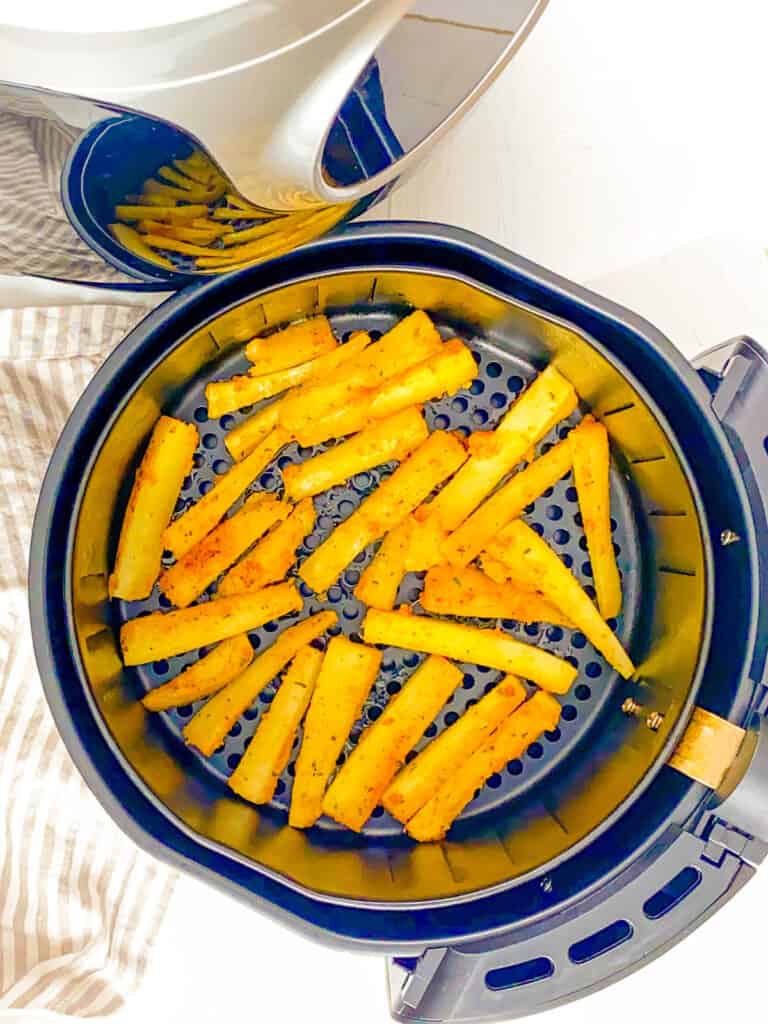 Cassava fries being cooked in an air fryer.