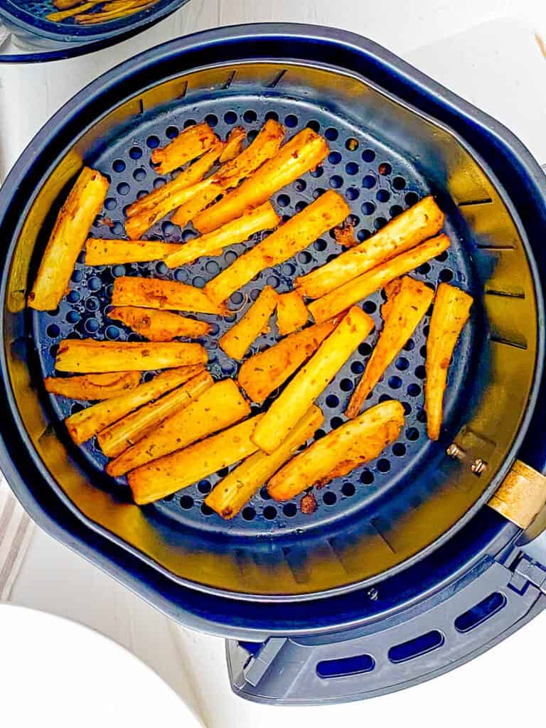 Cassava fries in an air fryer base.