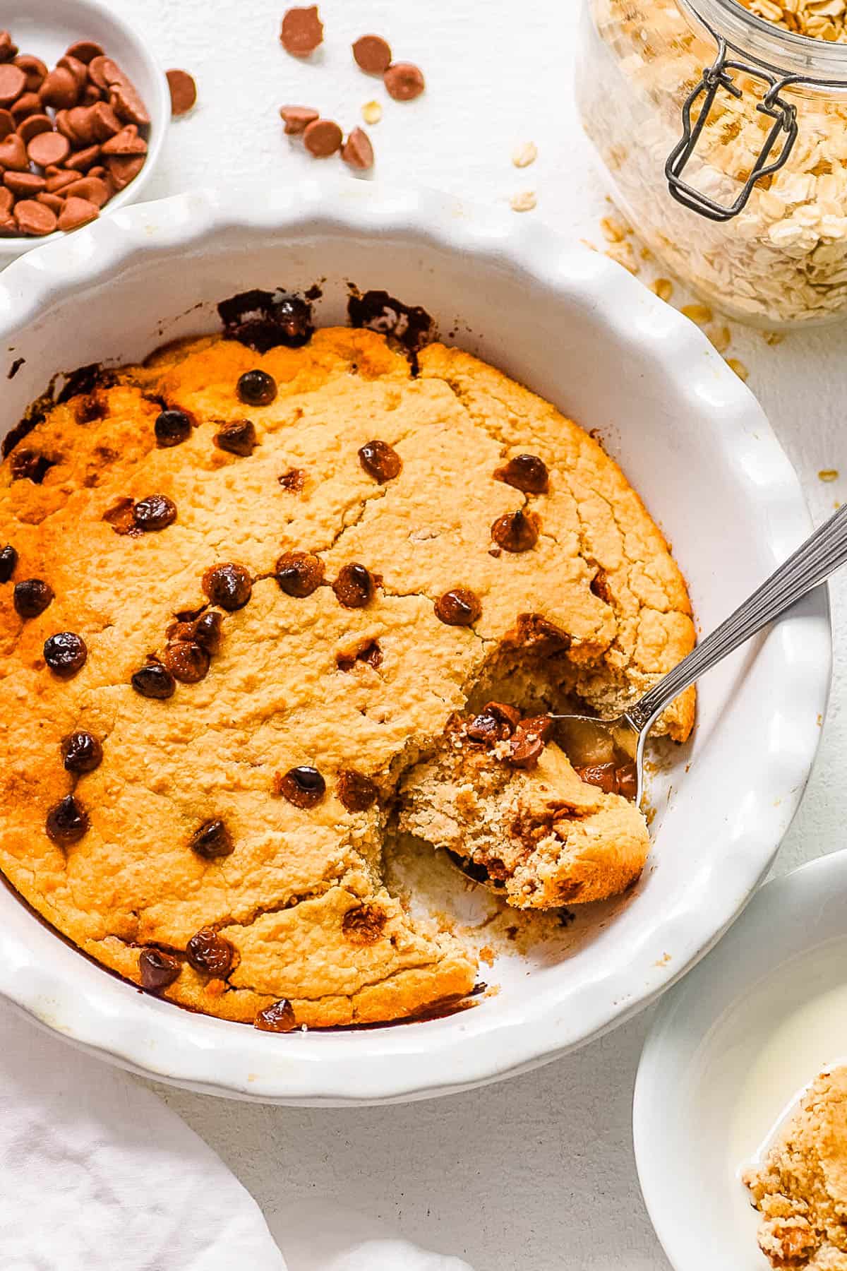 Healthy chocolate chip baked oats in a white baking dish.