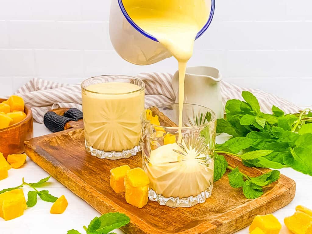 Healthy protein mango smoothie poured into glass cups.