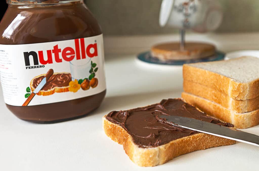 Nutella chocolate cream spread on a piece of toast. 
