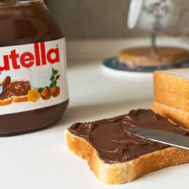 Nutella chocolate cream spread on a piece of toast.