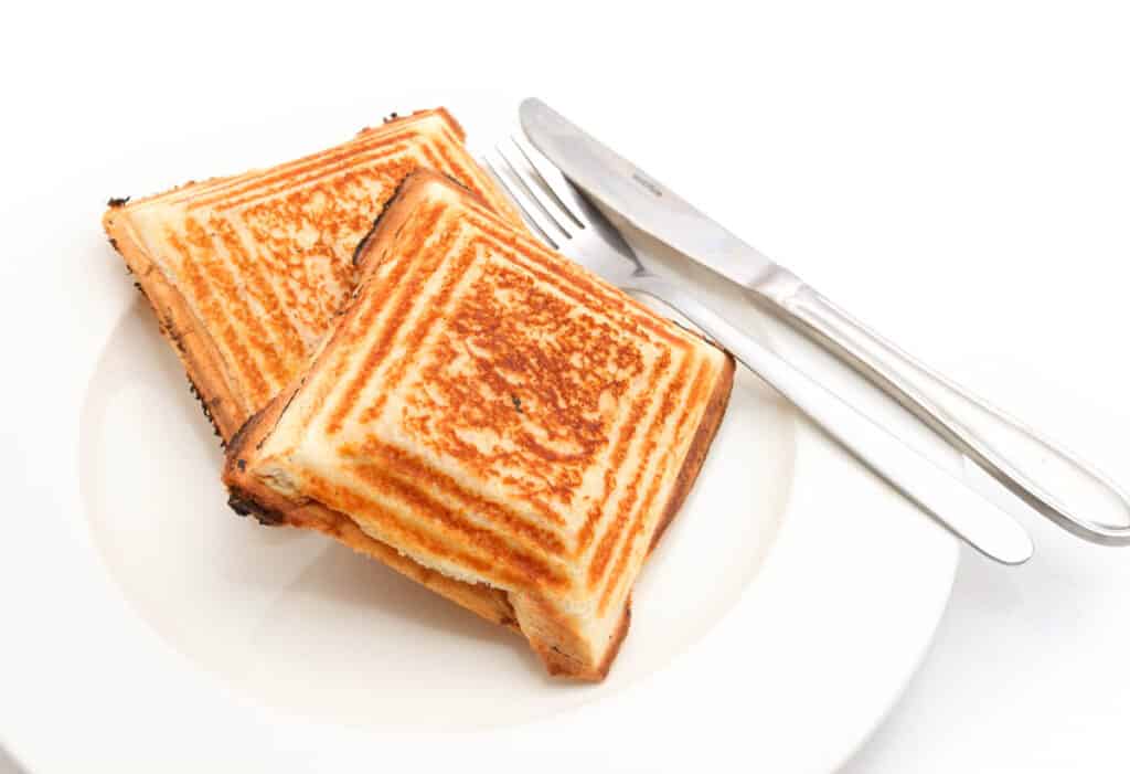 Jaffle or grilled sandwich on a white plate.