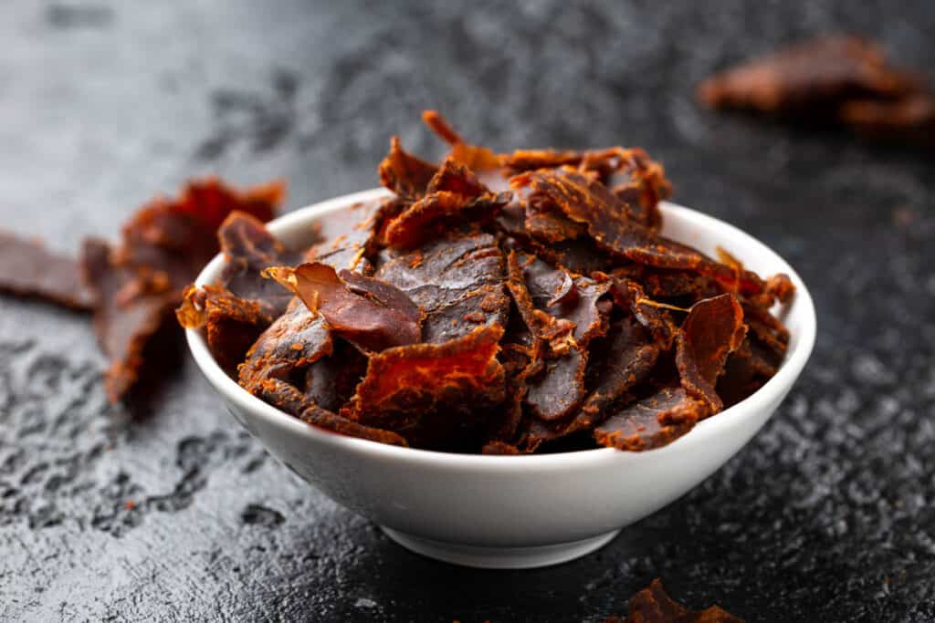 Dried Beef Jerky snack in white bowl.