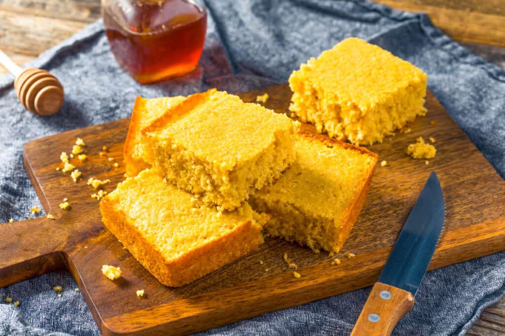 Jiffy cornbread on a wooden cutting board.