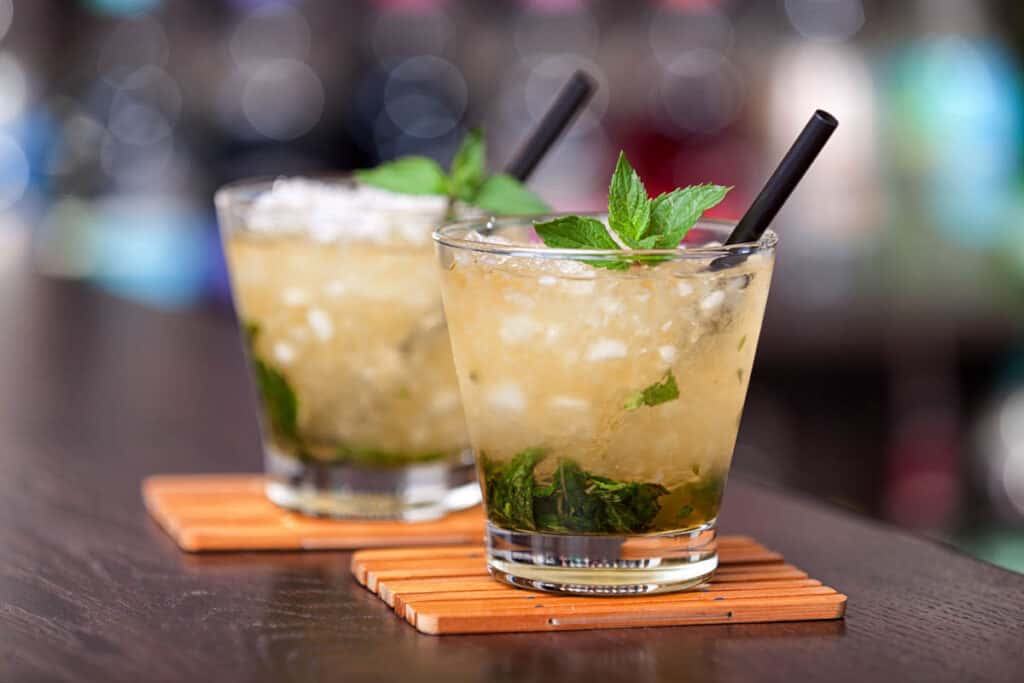 Two cocktails - Mint Julep on a bar counter.